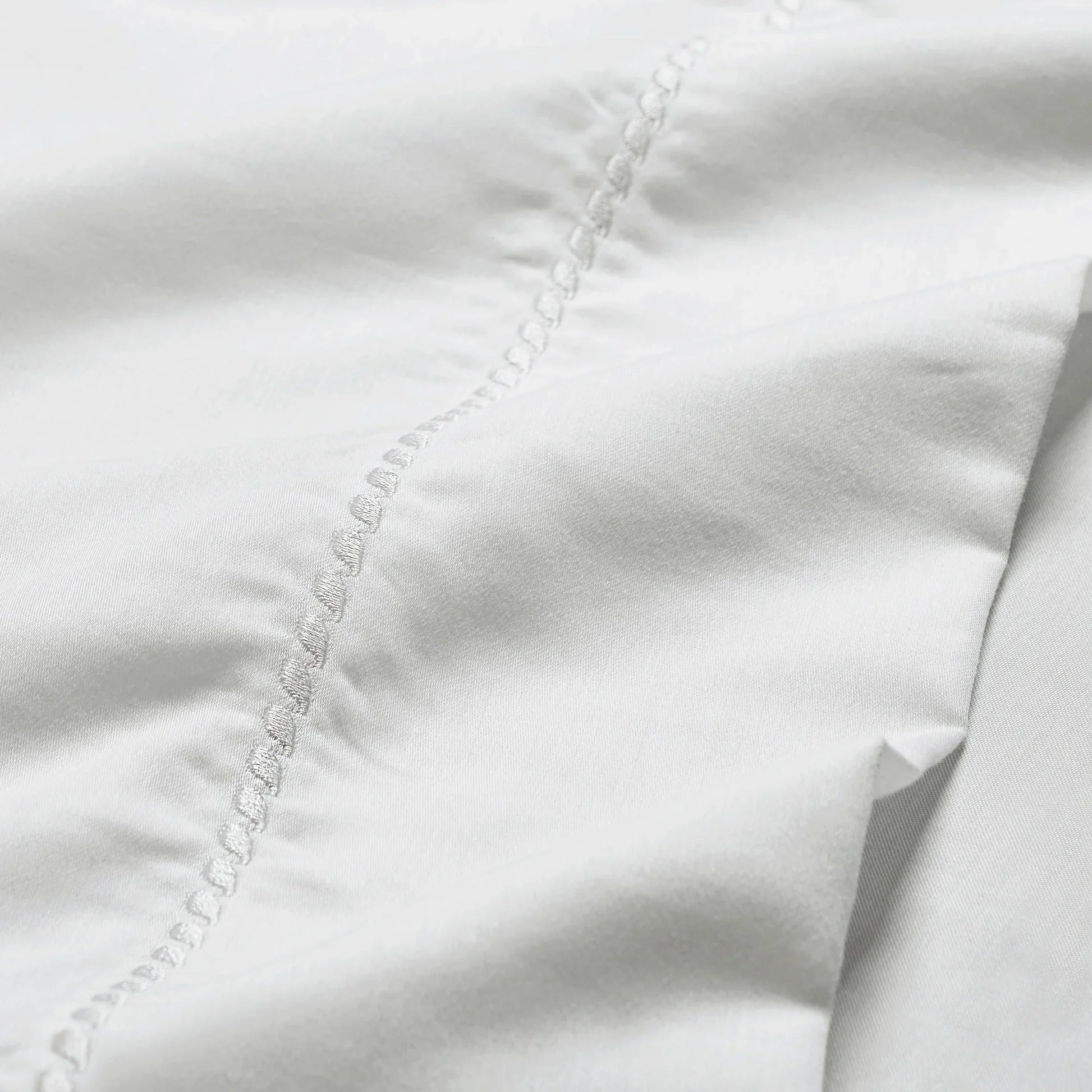 White 600 Thread Count Cotton Blend Bed Sheet Set Imperia embroidery detail close-up texture.