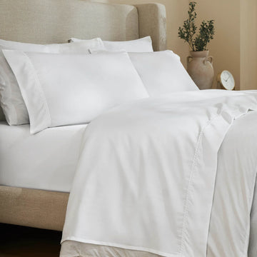 White 600 Thread Count Cotton Blend Bed Sheet Set with Imperia embroidered hem details on a luxury lifestyle bed display.