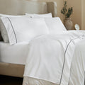 White/Black 600 Thread Count Cotton Blend Bed Sheet Set with Imperia embroidered hem details on a luxury lifestyle bed display.