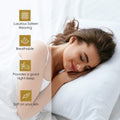 Woman sleeping on a white pillow with product feature icons