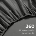 Close-up of an gray fitted sheet with 360-degree elastic for a secure fit around the mattress.