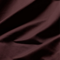 Close-up of smooth plum Egyptian cotton fabric with a lustrous sateen weave and soft drape.
